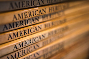 A stack of old "American eritage books" from the Oak Hill Grange Library